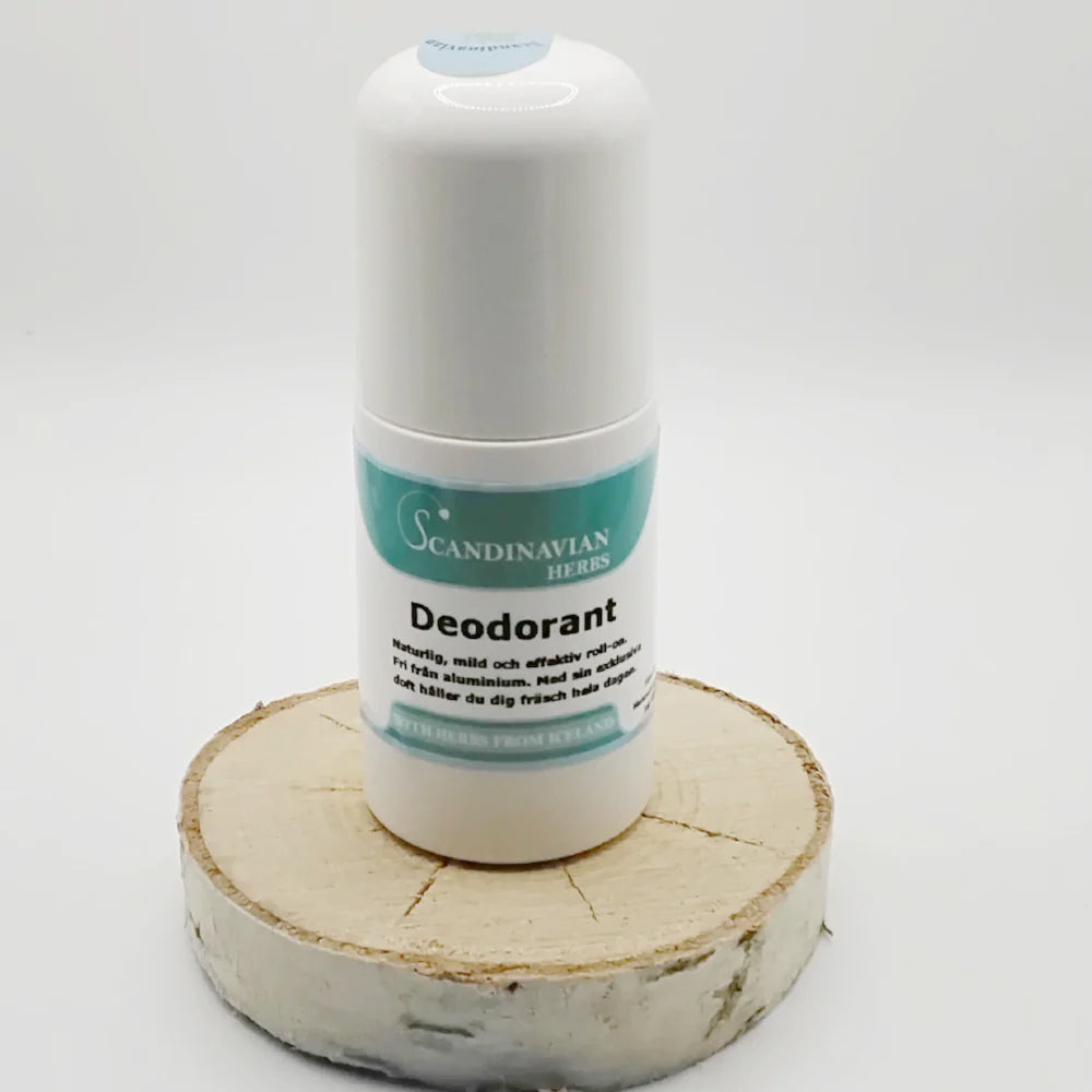 A white cylindrical deodorant bottle from Scandinavian Herbs sits on a wooden base. The Swedish label reads naturlig ingredienser and features a blue-white design. It has a light blue cap with text, ideal for känslig hud.