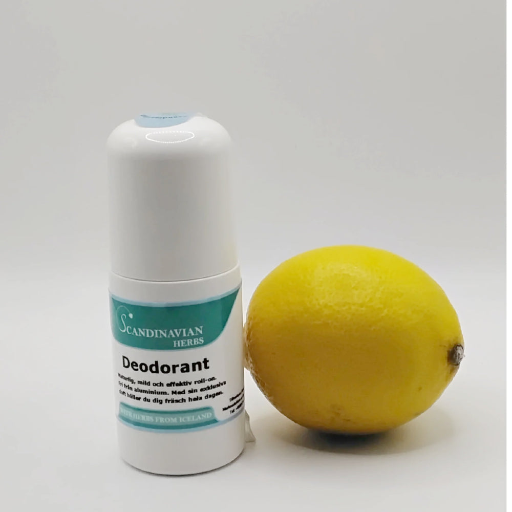 A white cylindrical deodorant bottle labeled Deodorant - naturlig och aluminiumfri by Scandinavian Herbs, meant for känslig hud and made with naturliga ingredienser, sits beside a whole yellow lemon on a white background.