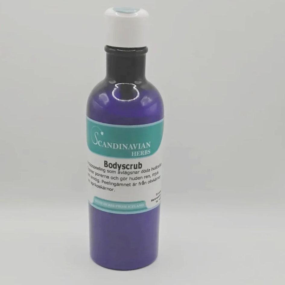 The Scandinavian Herbs Bodyscrub, a sleek blue bottle with a white cap and a green-and-white label, elegantly showcases its exquisite formula with olivkärnor against a plain backdrop.