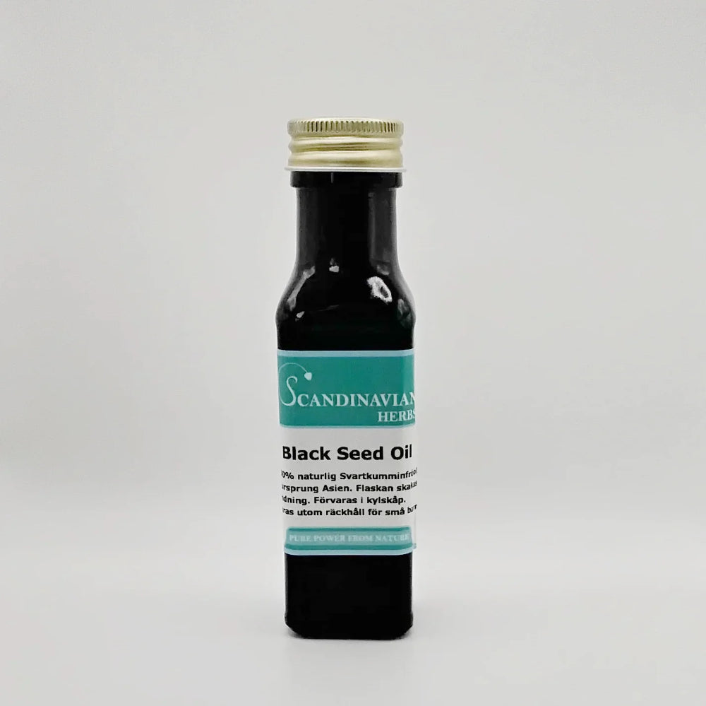 A small bottle of Scandinavian Herbs Black Seed Oil - svartkumminolja with a gold cap features the product name and multilingual text on the label. The dark bottle of this naturlig olja beautifully contrasts with the light background.