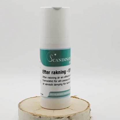 A white bottle with a teal label reading Efter rakning kräm - after shave by Scandinavian Herbs stands on a wooden slice. Its enriched with naturliga oljor for känslig hy, suggesting an aftershave product. The background is plain and white.