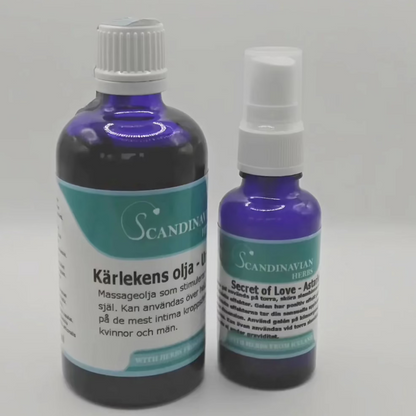 Two blue bottles with white caps and Swedish labels stand out. The larger is Kärlekens olja, known for its afrodisiaka effekter, and the smaller is Secret of Love. Offered by Scandinavian Herbs in their Kärlekspaket- en relationshöjare, they’re ideal for an enchanting massage experience.